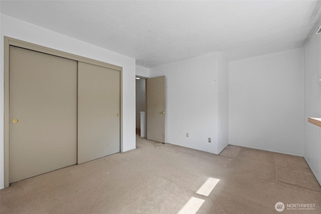 2300 9th Ave SW Unit C1, Olympia, WA 98502 - unfurnished bedroom featuring light carpet and a closet