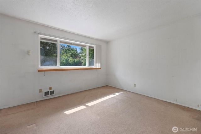 2300 9th Ave SW Unit C1, Olympia, WA 98502 - empty room featuring carpet flooring and a textured ceiling