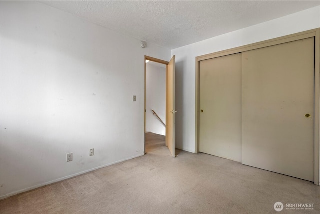 2300 9th Ave SW Unit C1, Olympia, WA 98502 - unfurnished bedroom with light colored carpet, a closet, and a textured ceiling