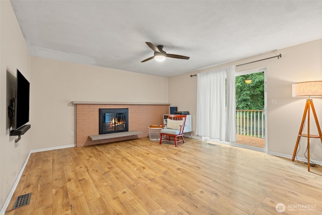 35804 15th Ave SW, Federal Way, WA 98023 - living area with wood-type flooring, ceiling fan, and a fireplace