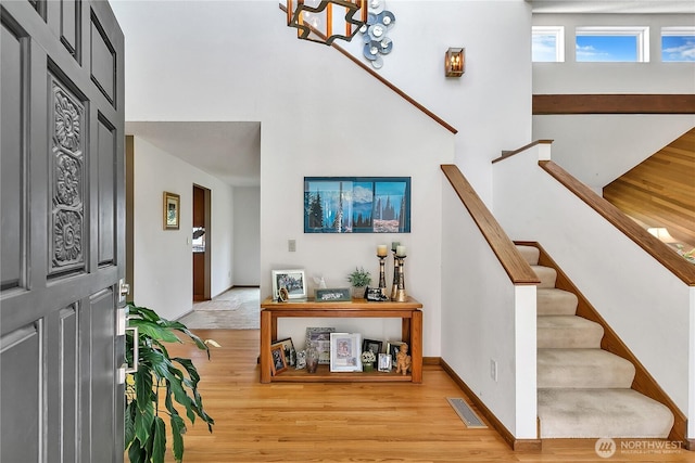 20219 SE 344th St, Auburn, WA 98092 - entrance foyer with light wood finished floors, stairs, baseboards, a high ceiling, and a chandelier