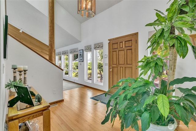 20219 SE 344th St, Auburn, WA 98092 - foyer featuring high vaulted ceiling, wood finished floors, a chandelier, and baseboards