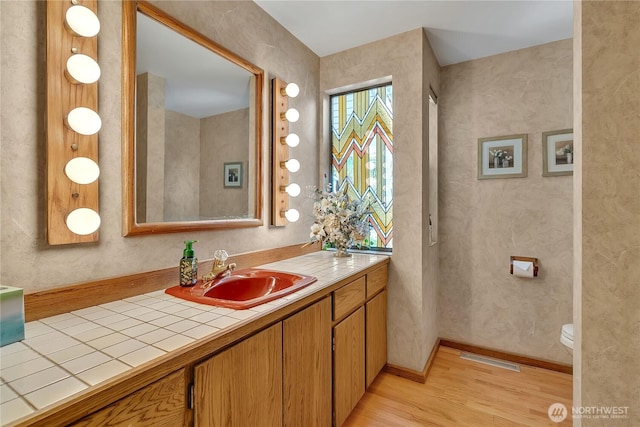 20219 SE 344th St, Auburn, WA 98092 - bathroom featuring wood finished floors, vanity, and toilet