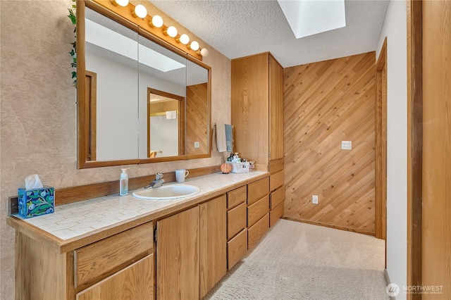 20219 SE 344th St, Auburn, WA 98092 - bathroom with a skylight, vanity, and wood walls