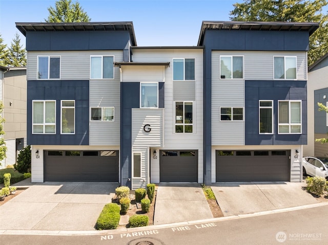 16201 Meadow Rd Unit G2, Lynnwood, WA 98087 - view of front facade featuring driveway and an attached garage
