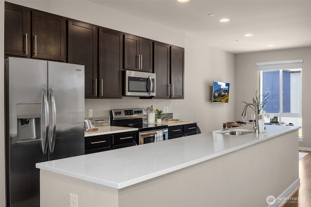 16201 Meadow Rd Unit G2, Lynnwood, WA 98087 - kitchen featuring appliances with stainless steel finishes, a sink, recessed lighting, light countertops, and dark brown cabinets