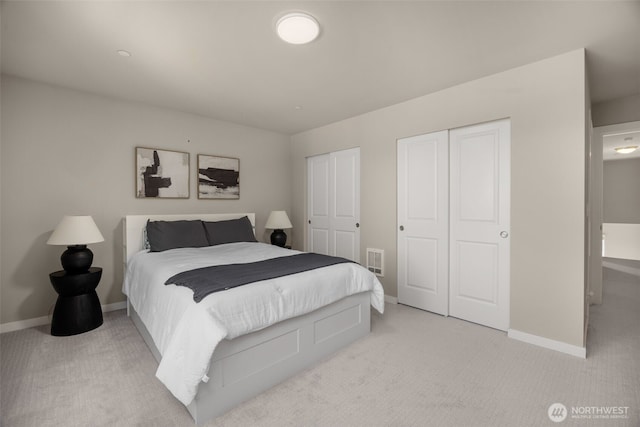 16201 Meadow Rd Unit G2, Lynnwood, WA 98087 - bedroom featuring light carpet, baseboards, and two closets