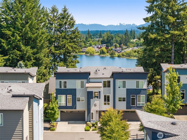 16201 Meadow Rd Unit G2, Lynnwood, WA 98087 - view of front of house with a water and mountain view, a garage, and roof with shingles