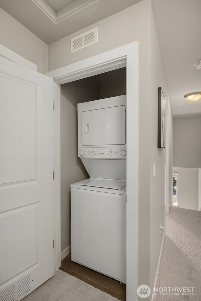 16201 Meadow Rd Unit G2, Lynnwood, WA 98087 - laundry room with estacked washer and dryer, baseboards, and carpet