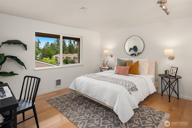 20101 61st Pl W Unit E-308, Lynnwood, WA 98036 - bedroom featuring wood finished floors and baseboards