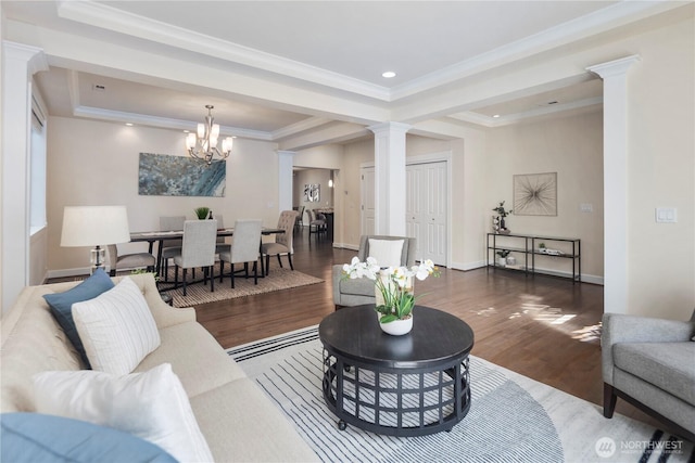 24332 NE 8th Pl, Sammamish, WA 98074 - living room featuring a raised ceiling, ornate columns, wood finished floors, a chandelier, and ornamental molding