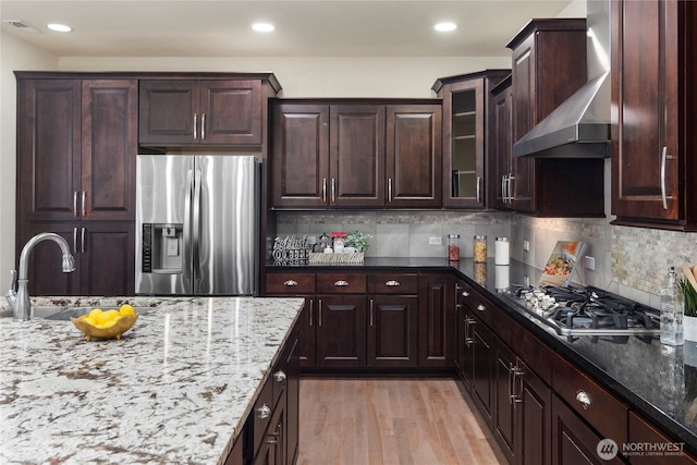 24332 NE 8th Pl, Sammamish, WA 98074 - kitchen with stainless steel appliances, wall chimney exhaust hood, a sink, light stone counters, and recessed lighting