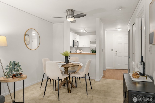 2244 13th Ave W Unit 106, Seattle, WA 98119 - dining room with ceiling fan and light carpet