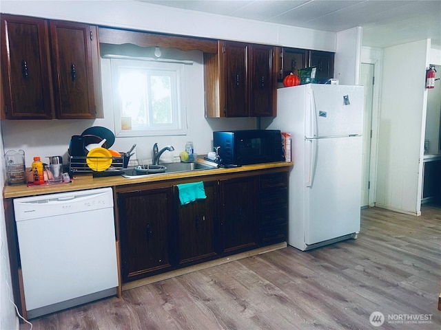 901 N Grapr Dr Unit 62, Moses Lake, WA 98837 - kitchen with white appliances, a sink, light wood finished floors, light countertops, and dark brown cabinetry
