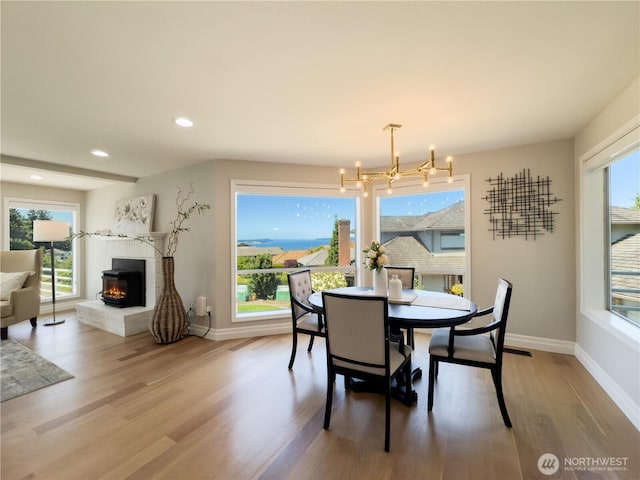 1621 Edgemoor Ln, Everett, WA 98203 - dining room with wood finished floors, a brick fireplace, a chandelier, baseboards, and recessed lighting