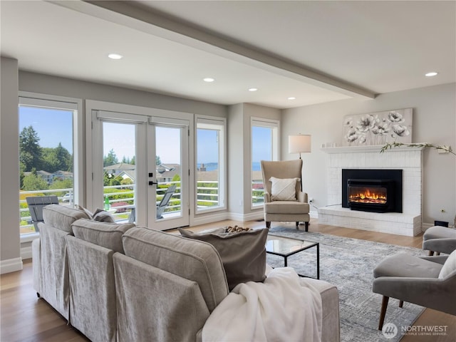 1621 Edgemoor Ln, Everett, WA 98203 - living room featuring healthy amount of natural light, a fireplace, wood finished floors, recessed lighting, and french doors