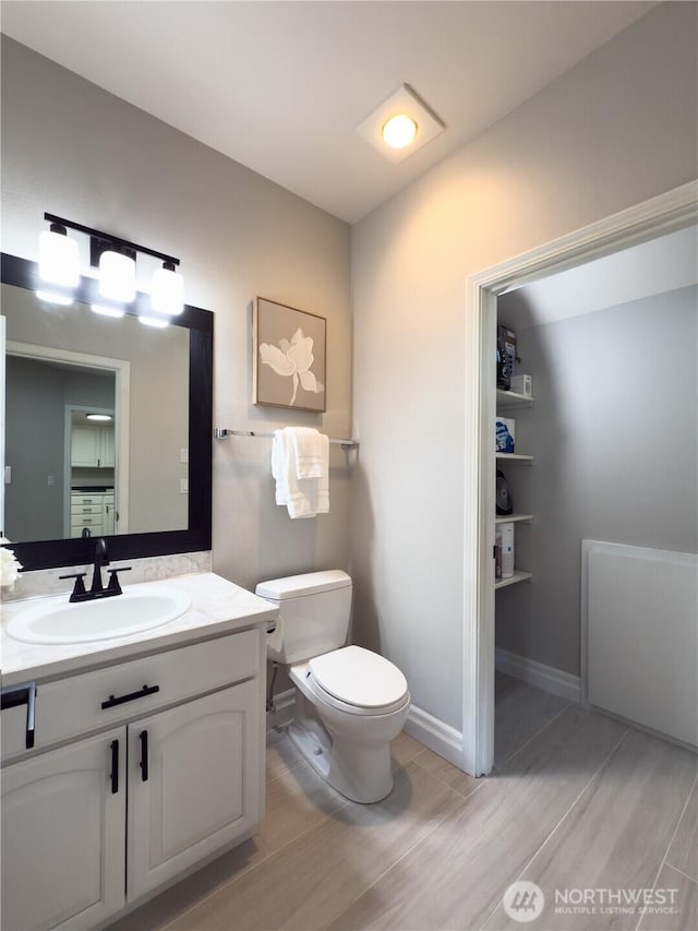 1621 Edgemoor Ln, Everett, WA 98203 - half bath with toilet, wood finished floors, vanity, and baseboards