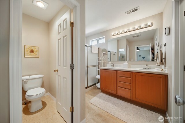 919 Carmella St, Walla Walla, WA 99362 - bathroom featuring double vanity, a shower stall, toilet, and baseboards