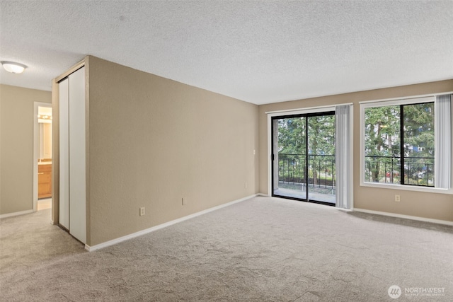 750 N 143rd St Unit 211, Seattle, WA 98133 - unfurnished room featuring carpet floors, a textured ceiling, and baseboards