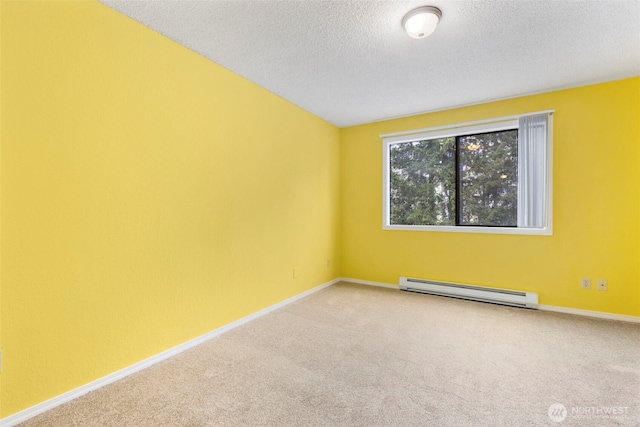 750 N 143rd St Unit 211, Seattle, WA 98133 - spare room with baseboard heating, carpet floors, a textured ceiling, and baseboards