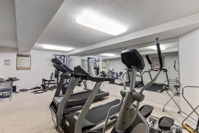 750 N 143rd St Unit 211, Seattle, WA 98133 - gym featuring a textured ceiling, baseboards, and carpet