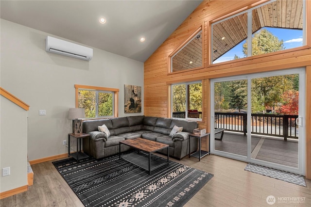 11175 Wending Ln, Leavenworth, WA 98826 - living area featuring a wall mounted air conditioner, high vaulted ceiling, wood finished floors, wood walls, and baseboards