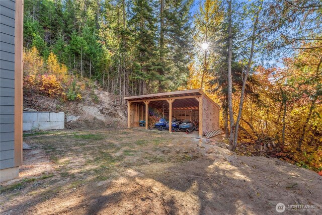 11175 Wending Ln, Leavenworth, WA 98826 - view of yard with a detached carport and a forest view