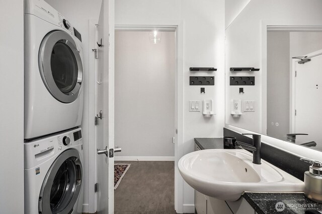501 Roy St Unit T308, Seattle, WA 98109 - laundry room with stacked washing machine and dryer, carpet, and baseboards