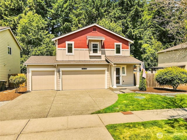 7600 Brianna Ct SE, Olympia, WA 98513 - view of front of house with concrete driveway, board and batten siding, an attached garage, a shingled roof, and a garage