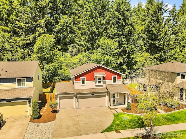 7600 Brianna Ct SE, Olympia, WA 98513 - view of front of property with concrete driveway, a shingled roof, a garage, and board and batten siding