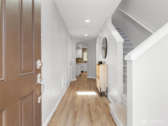 7600 Brianna Ct SE, Olympia, WA 98513 - entryway featuring light wood-style flooring, stairs, baseboards, recessed lighting, and arched walkways