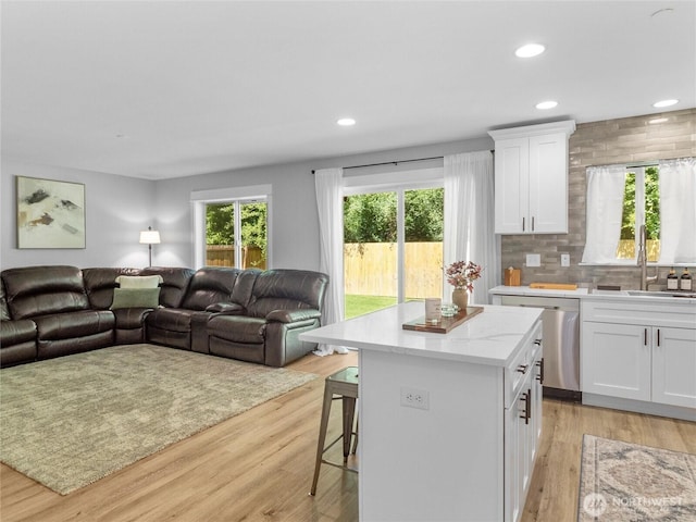 7600 Brianna Ct SE, Olympia, WA 98513 - kitchen featuring stainless steel dishwasher, open floor plan, a sink, a kitchen island, and recessed lighting