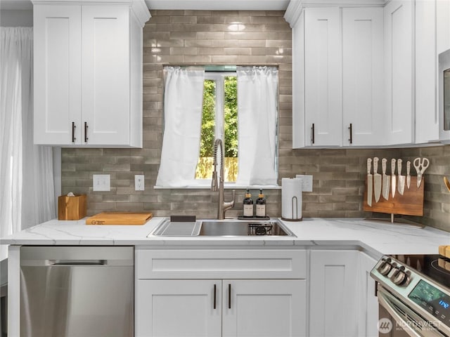 7600 Brianna Ct SE, Olympia, WA 98513 - kitchen featuring stainless steel appliances, a sink, tasteful backsplash, white cabinetry, and light stone counters