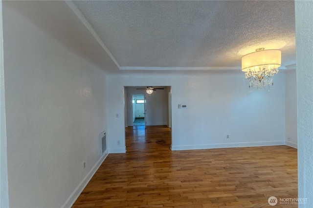 1035 Oakes Ave, Everett, WA 98201 - empty room featuring a textured ceiling, wood finished floors, a chandelier, baseboards, and ceiling fan
