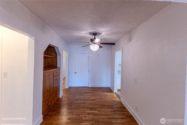 1035 Oakes Ave, Everett, WA 98201 - corridor with wood finished floors, a textured ceiling, and baseboards