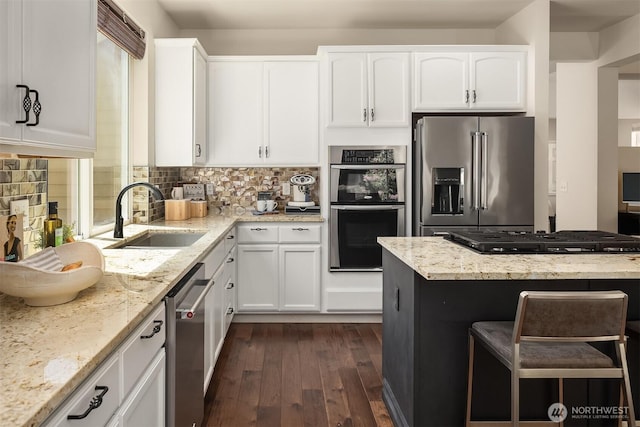 16148 Parkside Way SE, Renton, WA 98058 - kitchen featuring stainless steel appliances, a sink, dark wood-style floors, light stone counters, and white cabinetry