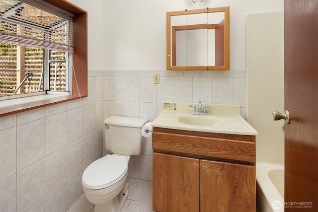 6207 182nd St SW, Lynnwood, WA 98037 - bathroom featuring toilet, vanity, tile walls, a bathtub, and tile patterned flooring