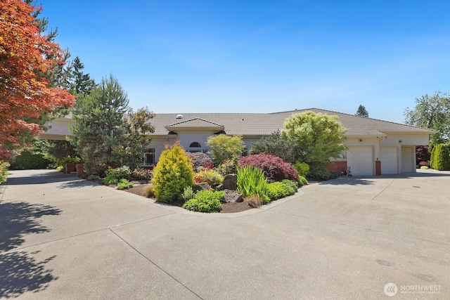 18737 63rd Ave NE, Kenmore, WA 98028 - view of front facade with a tiled roof, driveway, an attached garage, and stucco siding