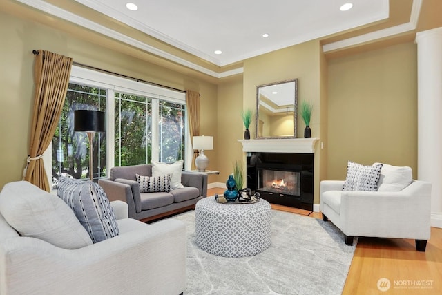 18737 63rd Ave NE, Kenmore, WA 98028 - living area featuring wood finished floors, crown molding, a glass covered fireplace, recessed lighting, and baseboards