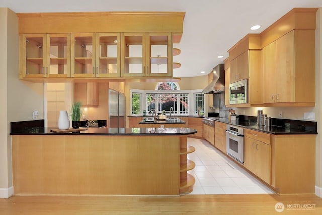 18737 63rd Ave NE, Kenmore, WA 98028 - kitchen featuring built in appliances, a peninsula, wall chimney exhaust hood, glass insert cabinets, and recessed lighting