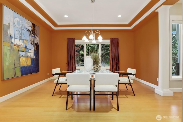 18737 63rd Ave NE, Kenmore, WA 98028 - dining space with decorative columns, light wood finished floors, a tray ceiling, crown molding, and baseboards