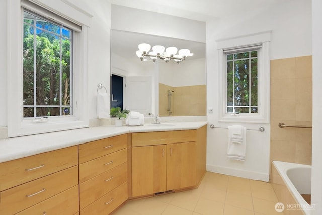 18737 63rd Ave NE, Kenmore, WA 98028 - bathroom featuring tile patterned floors, vanity, a tub to relax in, a shower, and a chandelier