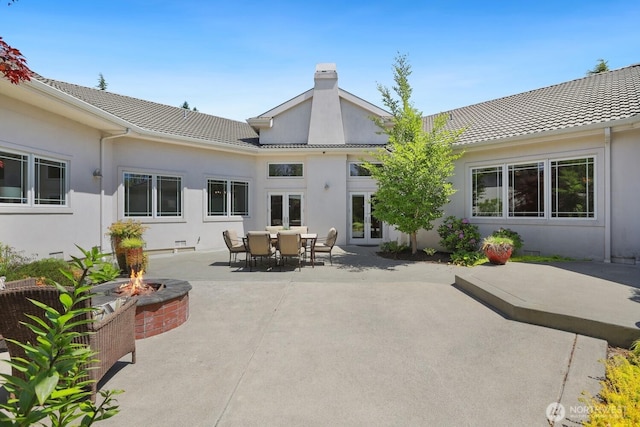18737 63rd Ave NE, Kenmore, WA 98028 - rear view of house featuring a fire pit, a chimney, a patio area, a tile roof, and stucco siding