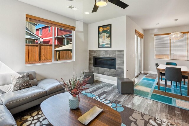 458 SW 111th Pl, Seattle, WA 98146 - living room with wood finished floors, a ceiling fan, a premium fireplace, and baseboards