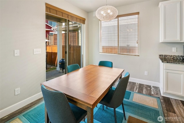 458 SW 111th Pl, Seattle, WA 98146 - dining area with baseboards, dark wood-style flooring, and a chandelier