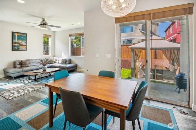 458 SW 111th Pl, Seattle, WA 98146 - dining area featuring wood finished floors, a chandelier, a ceiling fan, recessed lighting, and baseboards