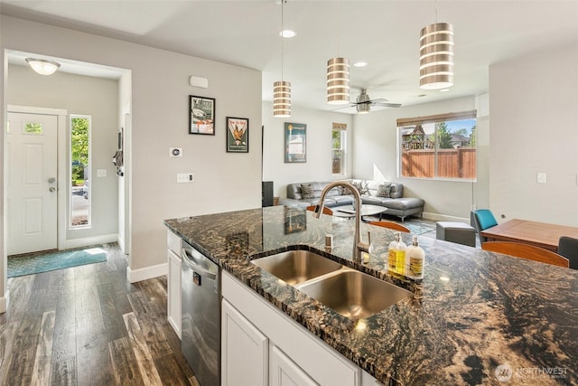 458 SW 111th Pl, Seattle, WA 98146 - kitchen with stainless steel dishwasher, a sink, dark wood-type flooring, baseboards, and pendant lighting