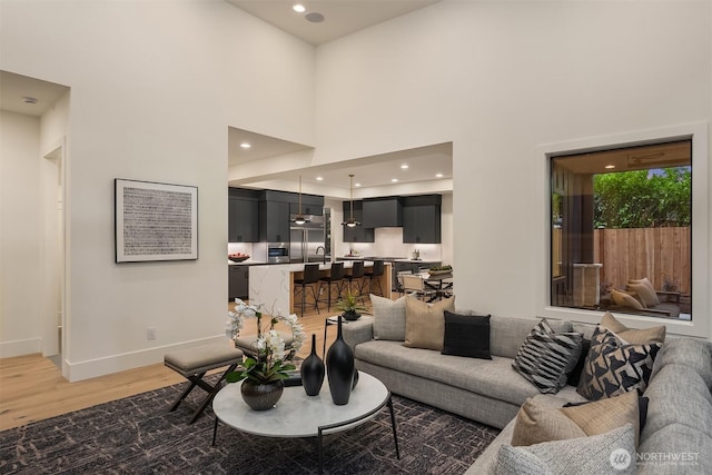 2505 166th Ave SE, Bellevue, WA 98008 - living area with light wood-style floors, a high ceiling, baseboards, and recessed lighting
