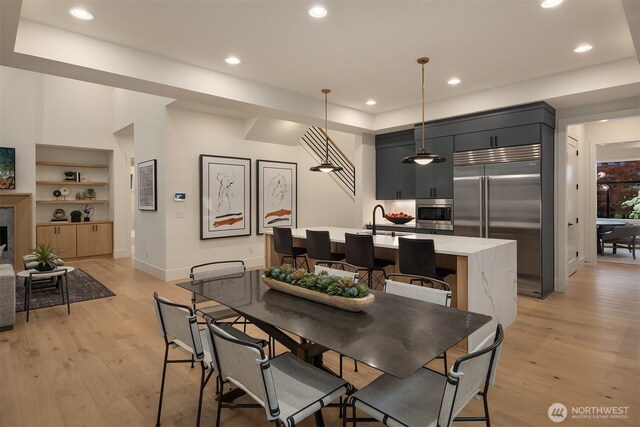 2505 166th Ave SE, Bellevue, WA 98008 - dining room with light wood-style flooring, recessed lighting, baseboards, and built in shelves