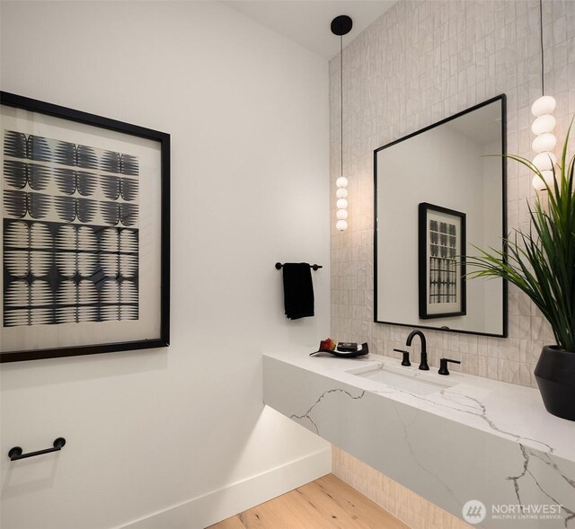 2505 166th Ave SE, Bellevue, WA 98008 - bathroom with wood finished floors, baseboards, vanity, and decorative backsplash